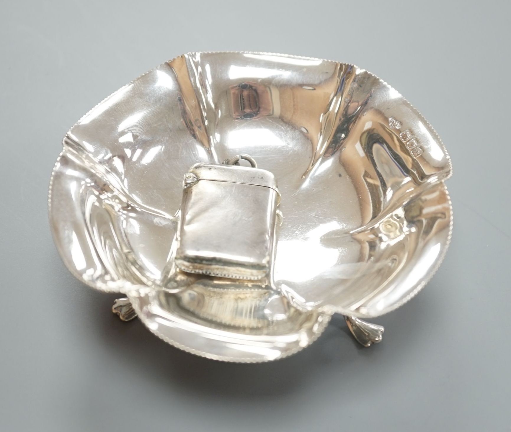 A late Victorian silver vesta case, Lucas & Co, Birmingham, 1898 and a later silver dish by Goldsmiths & Silversmiths Co Ltd, London, 1903.